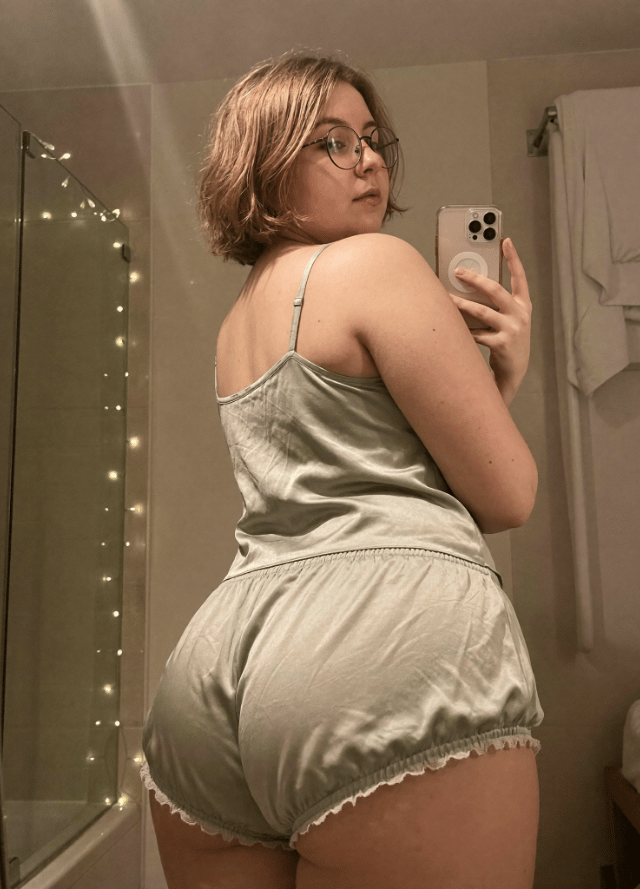An adult Joi character in an official mirror-selfie portrait.